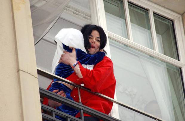 Michael Jackson and son on the balcony of his $40000 suite at the Adlon Hotel in Berlin, Germany. Photo / Getty 