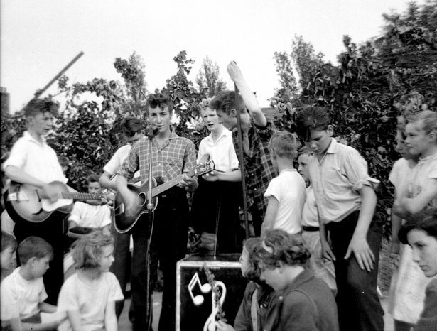Geoff Rhind's famous image shows John Lennon performing at St Peter's Church Fete in Woolton on the day he met Paul McCartney