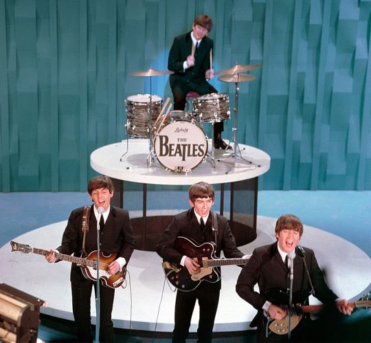The Beatles perform on "The Ed Sullivan Show" in New York on February 9, 1964. From left, front, are Paul McCartney, George Harrison and John Lennon. Ringo Starr plays drums. (AP Photo)
