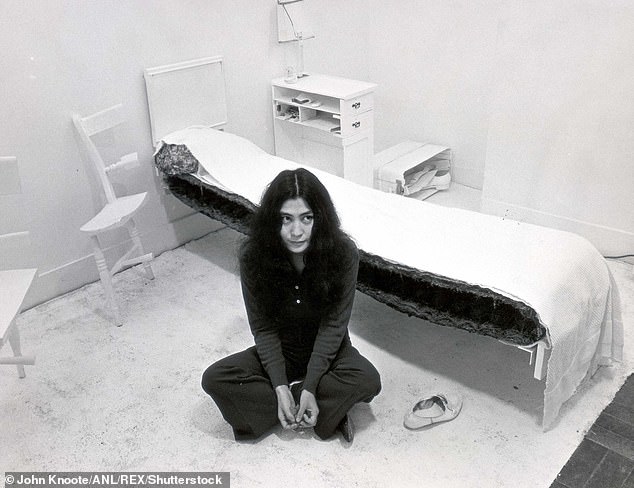 Yoko had John finance her art project that featured a room that had half of every object. Pictured: Yoko sitting in her 'half bedroom' in 1968