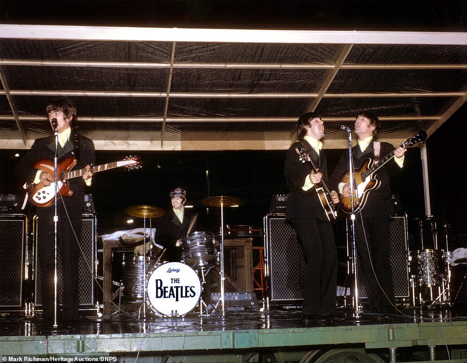 The beatles perform at the Busch Stadium in St Louis, Missouri on their 1966 US tour, in this color photo from a set now up for auction