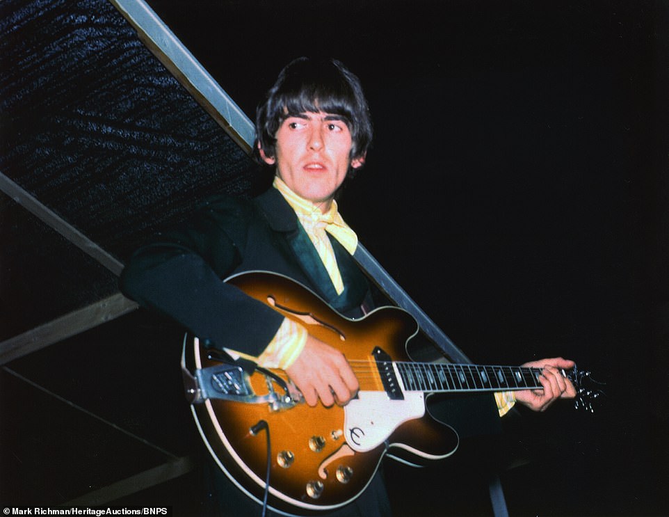 Beatle George Harrison looks tense as he plays his guitar, in this photo taken by Mark Richman at the 1966 St Louis, Missouri concert