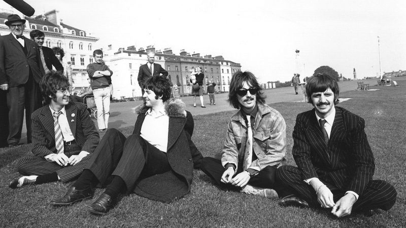 The Beatles, (left to right) John Lennon, Paul McCartney, George Harrison and Ringo Starr, take a break during the filming of "The Magical Mystery Tour" at Plymouth Hoe on Sept. 13, 1967.