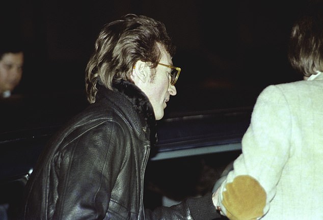 After signing Double Fantasy album for the 25-year-old former security guard, John Lennon is photographed getting into his limousine - and is thought to be the last picture of him alive