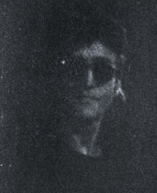 After signing the record album, John Lennon turns to the camera just as Goresh's flash fails, providing a ghostly black-and-white image