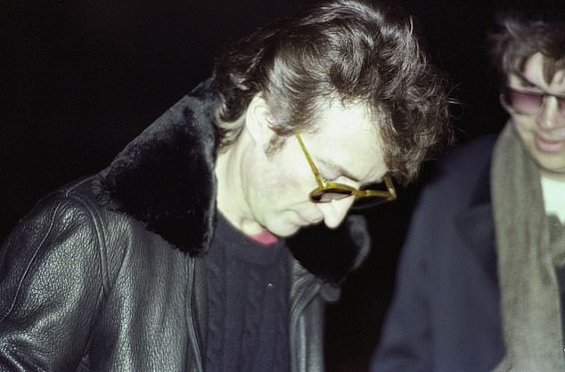 John Lennon is photographed for the last time signing a record album for his killer, Mark David Chapman at 4pm on December 8, 1980, in New York