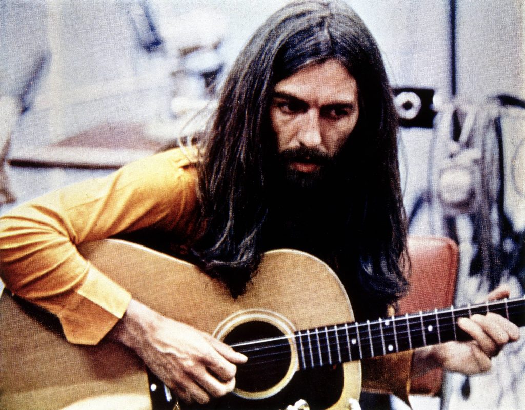 George Harrison holding a guitar